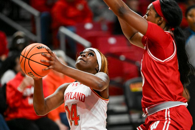 Feb 29, 2024; College Park, Maryland, USA;  Maryland Terrapins guard Bri McDaniel (24) shoots as Wisconsin Badgers forward Serah Williams (25) defends during the fist half at Xfinity Center. Mandatory Credit: Tommy Gilligan-USA TODAY Sports