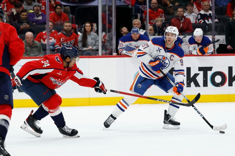 Nov 19, 2025; Washington, District of Columbia, USA; Edmonton Oilers center Connor McDavid (97) skates with the puck as Washington Capitals right wing Justin Sourdif (34) defends during the second period at Capital One Arena. Mandatory Credit: Geoff Burke-Imagn Images