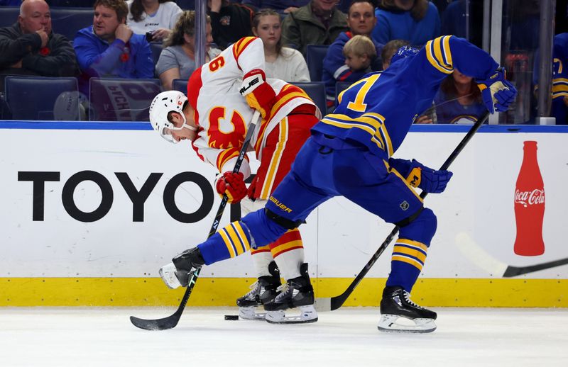 Nov 9, 2024; Buffalo, New York, USA;  Calgary Flames defenseman Brayden Pachal (94) and Buffalo Sabres center Ryan McLeod (71) go after a loose puck during the first period at KeyBank Center. Mandatory Credit: Timothy T. Ludwig-Imagn Images