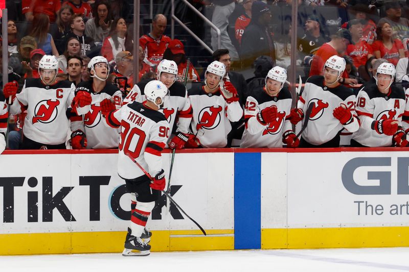 Oct 12, 2024; Washington, District of Columbia, USA; New Jersey Devils left wing Tomas Tatar (90) celebrates with teammates after scoring a goal against the Washington Capitals in the second period at Capital One Arena. Mandatory Credit: Geoff Burke-Imagn Images