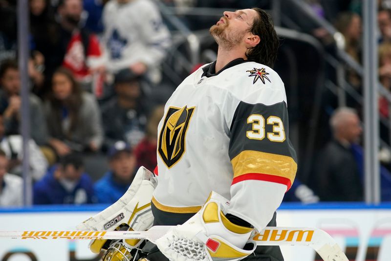 Nov 20, 2024; Toronto, Ontario, CAN; Vegas Golden Knights goaltender Adin Hill (33) during a break in the third period against the Toronto Maple Leafs at Scotiabank Arena. Mandatory Credit: John E. Sokolowski-Imagn Images