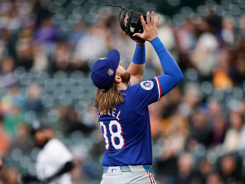 May 10, 2024; Denver, Colorado, USA; Texas Rangers third baseman Davis Wendzel (38) makes a catch for an out in the second inning against the Colorado Rockies at Coors Field. Mandatory Credit: Isaiah J. Downing-USA TODAY Sports