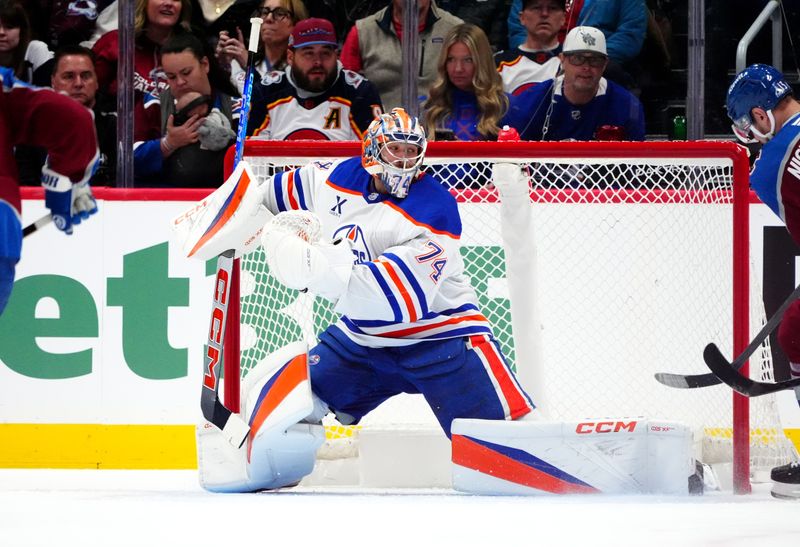 Nov 30, 2024; Denver, Colorado, USA; Edmonton Oilers goaltender Stuart Skinner (74) makes a save on Colorado Avalanche right wing Valeri Nichushkin (13) in the first period at Ball Arena. Mandatory Credit: Ron Chenoy-Imagn Images