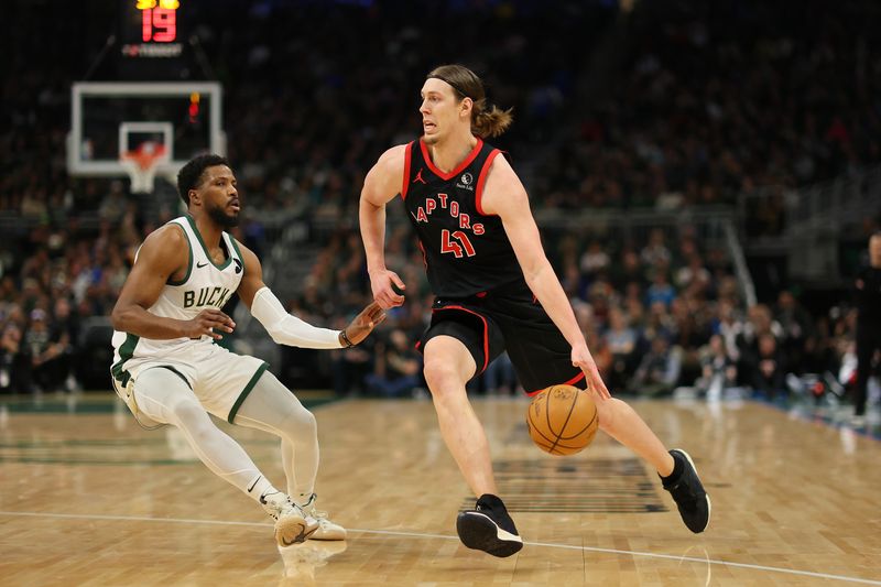 MILWAUKEE, WISCONSIN - APRIL 05: Kelly Olynyk #41 of the Toronto Raptors drives to the basket against Malik Beasley #5 of the Milwaukee Bucks during the first half of a game at Fiserv Forum on April 05, 2024 in Milwaukee, Wisconsin. NOTE TO USER: User expressly acknowledges and agrees that, by downloading and or using this photograph, User is consenting to the terms and conditions of the Getty Images License Agreement. (Photo by Stacy Revere/Getty Images)