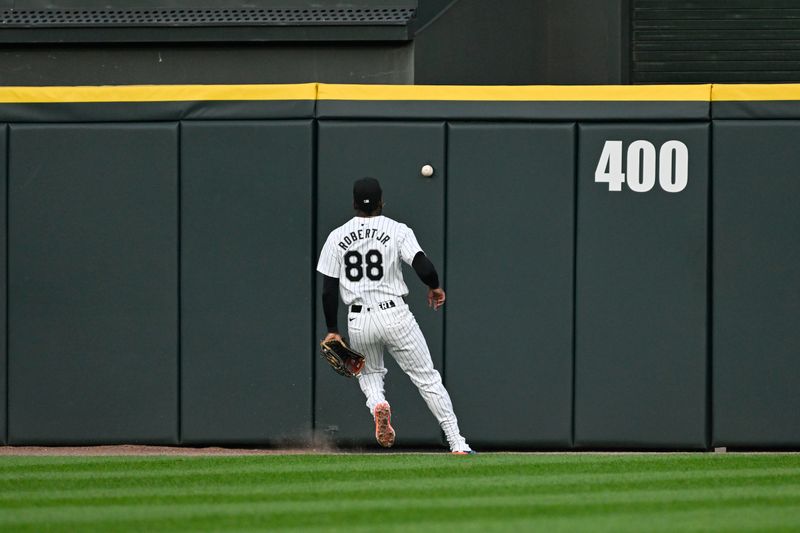 Jul 12, 2024; Chicago, Illinois, USA;  Chicago White Sox outfielder Luis Robert Jr. (88) watches the Pittsburgh Pirates outfielder Michael A. Taylor (18) double during the third inning against the Chicago White Sox at Guaranteed Rate Field. Mandatory Credit: Matt Marton-USA TODAY Sports