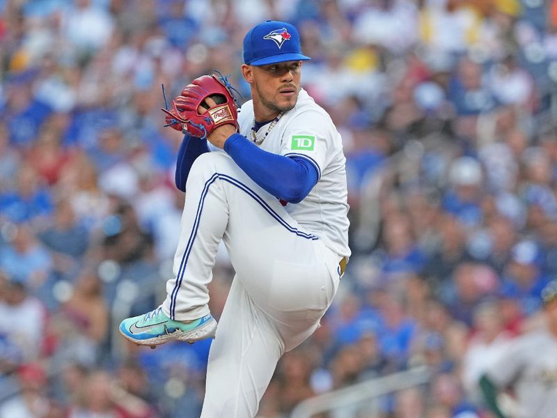 Aug 9, 2024; Toronto, Ontario, CAN; Toronto Blue Jays starting pitcher Jose Berríos (17) throws a pitch against the Oakland Athletics during the first inning at Rogers Centre. Mandatory Credit: Nick Turchiaro-USA TODAY Sports