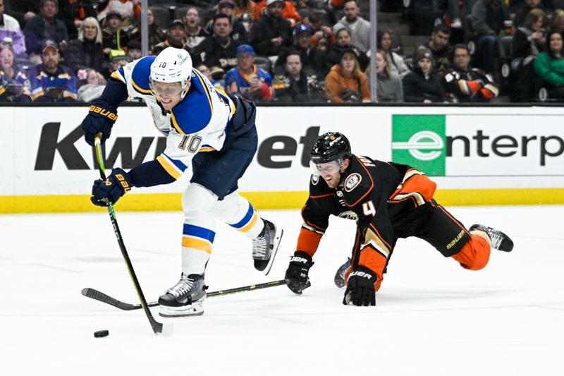 Mar 25, 2023; Anaheim, California, USA; St. Louis Blues center Brayden Schenn (10) shoots a shot in front of Anaheim Ducks defenseman Cam Fowler (4) during the second period at Honda Center. Mandatory Credit: Kelvin Kuo-USA TODAY Sports