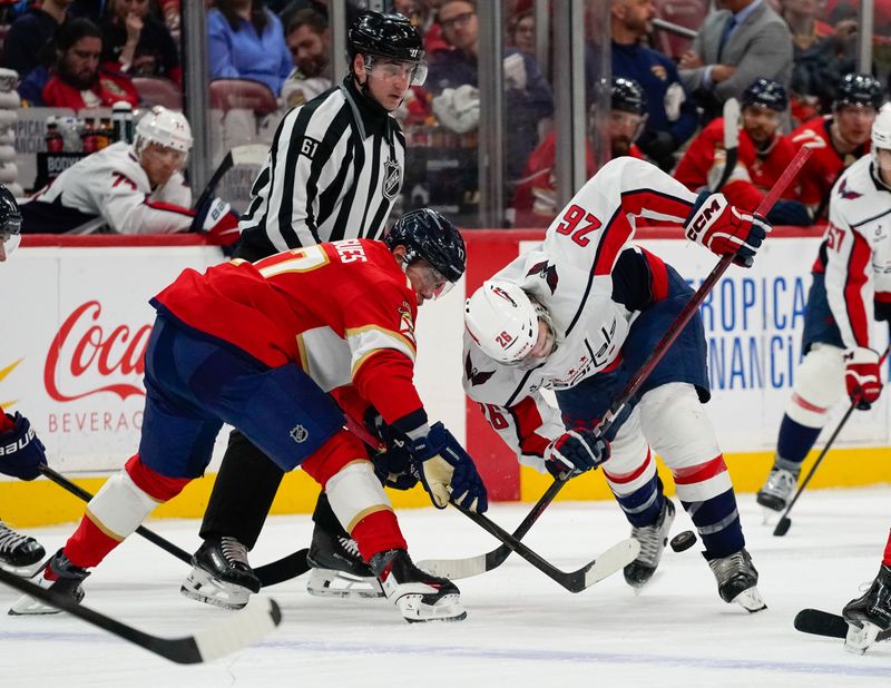 Dec 29, 2025; Sunrise, Florida, USA; Florida Panthers center Evan Rodrigues (17) and Washington Capitals center Nic Dowd (26) battle for the puck in a face off during the second period at Amerant Bank Arena. Mandatory Credit: Jeff Romance-Imagn Images