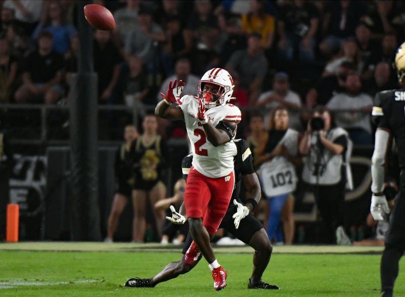 Sep 22, 2023; West Lafayette, Indiana, USA; Wisconsin Badgers cornerback Ricardo Hallman (2) intercepts a pass against Purdue Boilermakers wide receiver Deion Burks (4) during the second half at Ross-Ade Stadium. Mandatory Credit: Robert Goddin-USA TODAY Sports