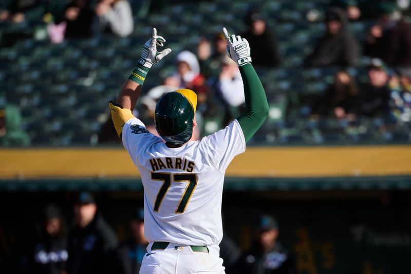 May 4, 2024; Oakland, California, USA; Oakland Athletics infielder Brett Harris (77) gestures toward the sky after hitting a one-run home run against the Miami Marlins for his first MLB career hit during the fourth inning at Oakland-Alameda County Coliseum. Mandatory Credit: Robert Edwards-USA TODAY Sports