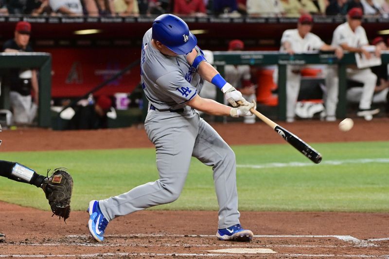 May 1, 2024; Phoenix, Arizona, USA;  Los Angeles Dodgers catcher Will Smith (16) hits a solo home run in the third inning against the Arizona Diamondbacksat Chase Field. Mandatory Credit: Matt Kartozian-USA TODAY Sports