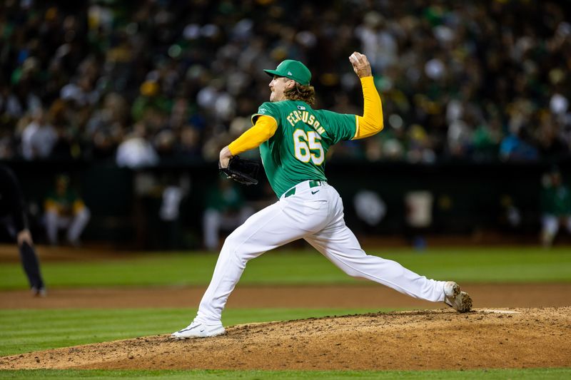 Sep 20, 2024; Oakland, California, USA; Oakland Athletics pitcher Tyler Ferguson (65) throws a pitch during the eighth inning against the New York Yankees at Oakland-Alameda County Coliseum. Mandatory Credit: Bob Kupbens-Imagn Images