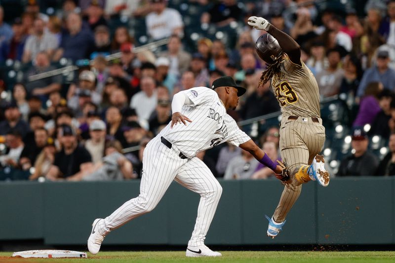 Apr 24, 2024; Denver, Colorado, USA; San Diego Padres right fielder Fernando Tatis Jr. (23) is tagged out by Colorado Rockies first baseman Elehuris Montero (44) in the fifth inning at Coors Field. Mandatory Credit: Isaiah J. Downing-USA TODAY Sports