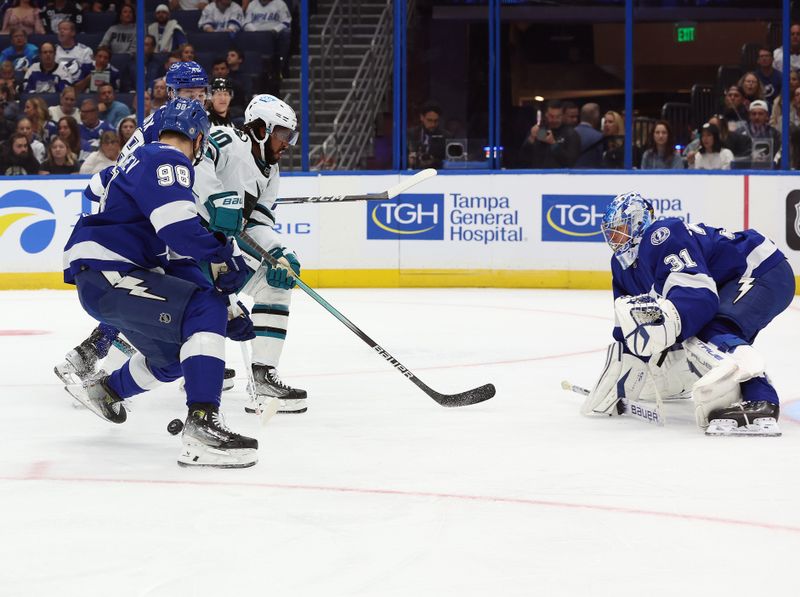 wOct 26, 2023; Tampa, Florida, USA; Tampa Bay Lightning defenseman Mikhail Sergachev (98) defends San Jose Sharks left wing Anthony Duclair (10) during the second period at Amalie Arena. Mandatory Credit: Kim Klement Neitzel-USA TODAY Sports