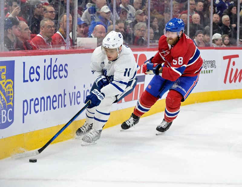 Apr 6, 2024; Montreal, Quebec, CAN; Toronto Maple Leafs forward Max Domi (11) plays the puck and Montreal Canadiens defenseman David Savard (58) defends during the third period at the Bell Centre. Mandatory Credit: Eric Bolte-USA TODAY Sports