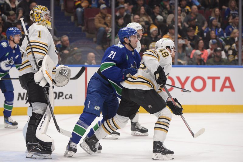 Feb 24, 2024; Vancouver, British Columbia, CAN;  Boston Bruins goaltender Jeremy Swayman (1) and defenseman Matt Grzelcyk (48) defend against Vancouver Canucks forward Nils Hoglander (21) during the first period at Rogers Arena. Mandatory Credit: Anne-Marie Sorvin-USA TODAY Sports