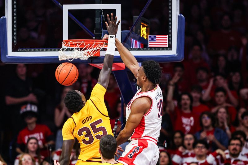 Jan 14, 2026; Tucson, Arizona, USA; Arizona Wildcats forward Tobe Awaka (30) dunks the ball over Arizona State Sun Devils center Massamba Diop (35) during the first half of the game at McKale Memorial Center. Mandatory Credit: Aryanna Frank-Imagn Images