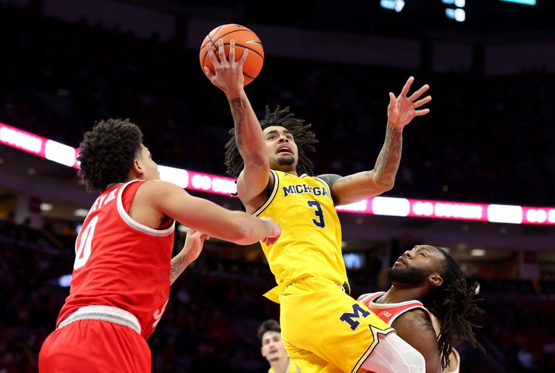 Feb 8, 2026; Columbus, Ohio, USA;  Michigan Wolverines guard Elliot Cadeau (3) drives to the basket as Ohio State Buckeyes guard Bruce Thornton (2) and guard John Mobley Jr. (0) defend during the first half at Value City Arena. Mandatory Credit: Joseph Maiorana-Imagn Images