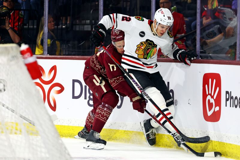 Mar 5, 2024; Tempe, Arizona, USA;  Arizona Coyotes center Nick Bjugstad (17) goes for the puck against Chicago Blackhawks defenseman Alex Vlasic (72) during the second period at Mullett Arena. Mandatory Credit: Mark J. Rebilas-USA TODAY Sports