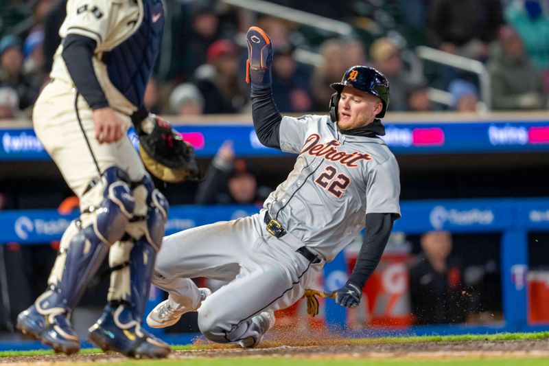 Apr 19, 2024; Minneapolis, Minnesota, USA; Detroit Tigers center fielder Parker Meadows (22) slides into home plate for a go ahead run against the Minnesota Twins in the ninth inning at Target Field. Mandatory Credit: Jesse Johnson-USA TODAY Sports