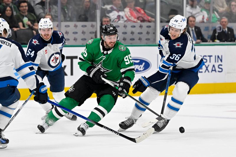 Feb 29, 2024; Dallas, Texas, USA; Dallas Stars center Matt Duchene (95) and Winnipeg Jets center Morgan Barron (36) battle for control of the puck during the second period at the American Airlines Center. Mandatory Credit: Jerome Miron-USA TODAY Sports