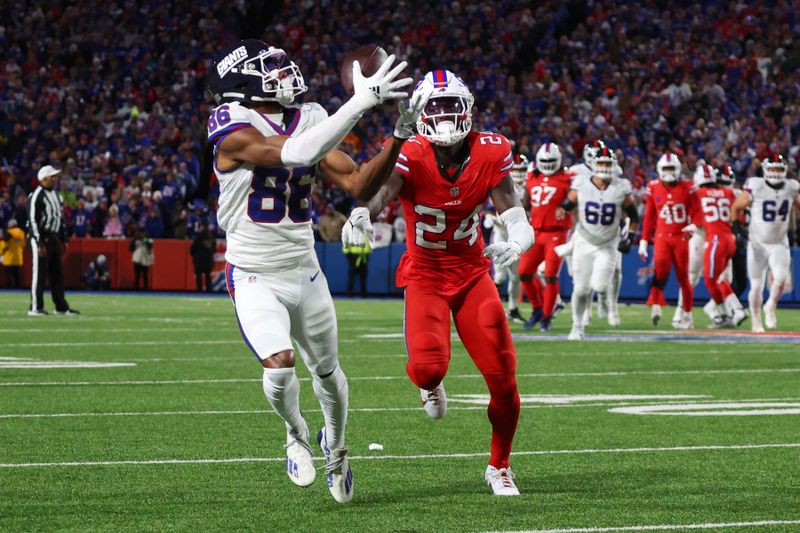 New York Giants wide receiver Darius Slayton (86) makes a catch past Buffalo Bills cornerback Kaiir Elam (24) during the first half of an NFL football game in Orchard Park, N.Y., Sunday Oct. 15, 2023. (AP Photo/ Jeffrey T. Barnes)