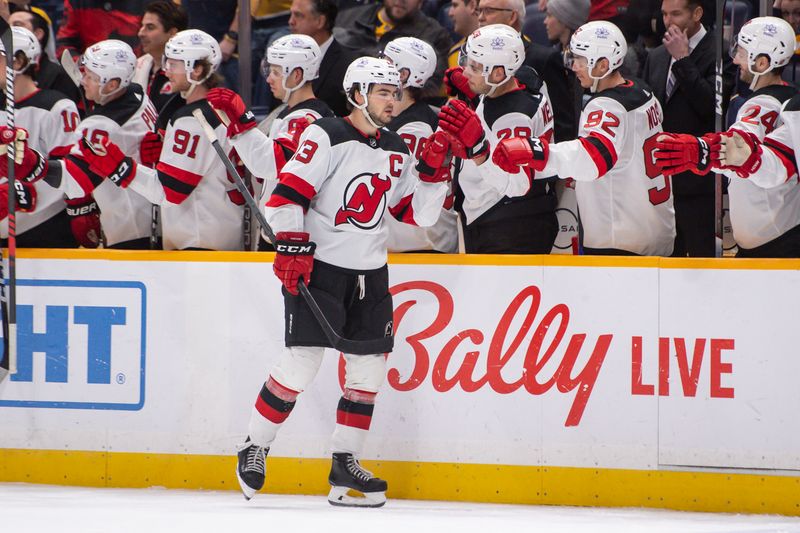 Feb 13, 2024; Nashville, Tennessee, USA;  New Jersey Devils left wing Jesper Bratt (63) celebrates his goal against the Nashville Predators during the third period at Bridgestone Arena. Mandatory Credit: Steve Roberts-USA TODAY Sports