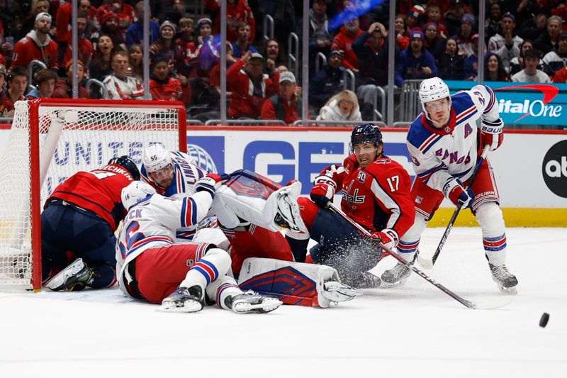 Jan 4, 2025; Washington, District of Columbia, USA; Washington Capitals and New York Rangers players battle rot ehpuck in front of New York Rangers goaltender Jonathan Quick (32) in the first period at Capital One Arena. Mandatory Credit: Geoff Burke-Imagn Images