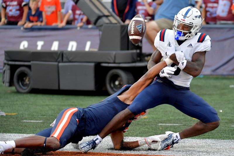 Sep 23, 2023; Champaign, Illinois, USA;  Illinois Fighting Illini defensive back Zachary Tobe (5) breaks up a pass reception by Florida Atlantic Owls wide receiver Je'Quan Burton (8) during the second half at Memorial Stadium. Mandatory Credit: Ron Johnson-USA TODAY Sports