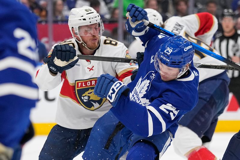 May 18, 2025; Toronto, Ontario, CAN; Florida Panthers defenseman Nate Schmidt (88) checks Toronto Maple Leafs forward Pontus Holmberg (29) during the third period of game seven of the second round of the 2025 Stanley Cup Playoffs at Scotiabank Arena. Mandatory Credit: John E. Sokolowski-Imagn Images
