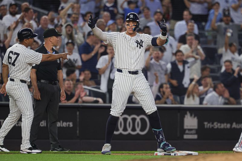 Jun 5, 2024; Bronx, New York, USA; New York Yankees center fielder Aaron Judge (99) reacts after hitting a three RBI triple during the fifth inning against the Minnesota Twins at Yankee Stadium. Mandatory Credit: Vincent Carchietta-USA TODAY Sports