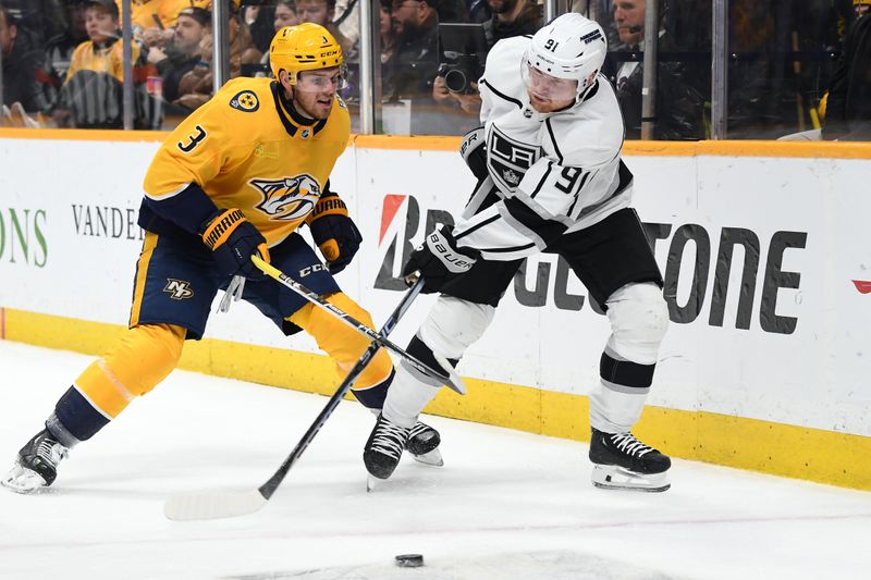 Jan 31, 2024; Nashville, Tennessee, USA; Los Angeles Kings right wing Carl Grundstrom (91) passes the puck as he is defended by Nashville Predators defenseman Jeremy Lauzon (3) during the second period at Bridgestone Arena. Mandatory Credit: Christopher Hanewinckel-USA TODAY Sports