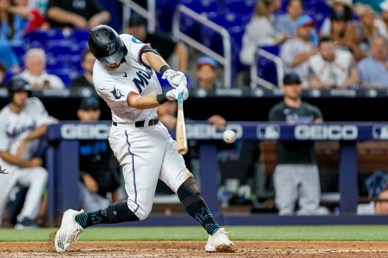 Jun 21, 2023; Miami, Florida, USA; Miami Marlins third baseman Garrett Hampson (1) hits an RBI single against the Toronto Blue Jays during the seventh inning at loanDepot Park. Mandatory Credit: Sam Navarro-USA TODAY Sports