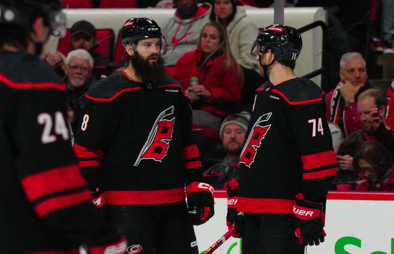 Jan 19, 2024; Raleigh, North Carolina, USA; Carolina Hurricanes defenseman Brent Burns (8) and defenseman Jaccob Slavin (74) against the Detroit Red Wings during the third period at PNC Arena. Mandatory Credit: James Guillory-USA TODAY Sports