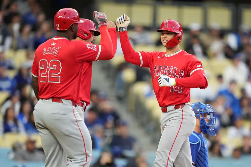 Mar 25, 2024; Los Angeles, California, USA; Los Angeles Angels catcher Logan O'Hoppe (14) celebrates with third baseman Miguel Sano (22) after hitting a three-run home run in the second inning against the Los Angeles Dodgers at Dodger Stadium. Mandatory Credit: Kirby Lee-USA TODAY Sports