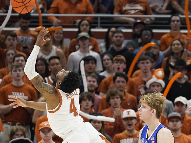 Mar 4, 2023; Austin, Texas, USA; Texas Longhorns guard Tyrese Hunter (4) shoots over Kansas Jayhawks guard Gradey Dick (4) during the second half at Moody Center. Mandatory Credit: Scott Wachter-USA TODAY Sports