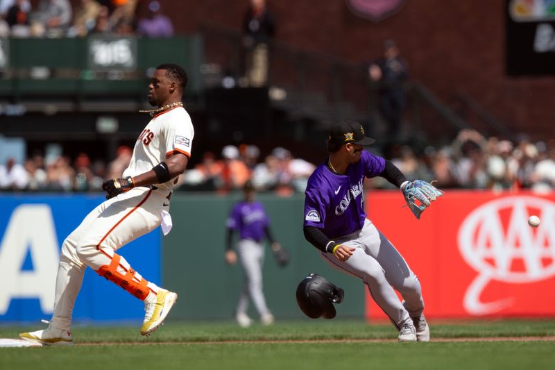 May 18, 2024; San Francisco, California, USA; San Francisco Giants designated hitter Jorge Soler (2) cruises into second base with a double ahead of the throw to  Colorado Rockies shortstop Ezequiel Tovar (14) during the eighth inning at Oracle Park. Mandatory Credit: D. Ross Cameron-USA TODAY Sports