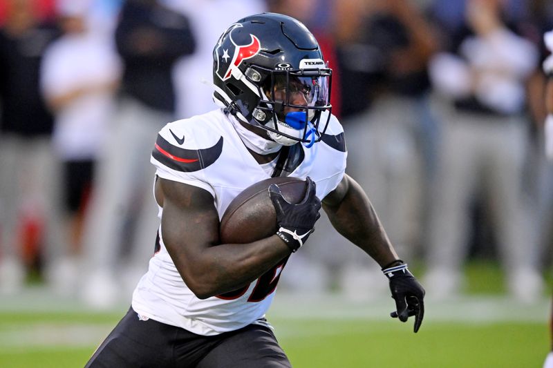 Houston Texans running back J.J. Taylor carries the ball first half of the NFL exhibition Hall of Fame football game against Chicago Bears, in Canton, Ohio, Thursday, Aug. 1, 2024. (AP Photo/Gene J. Puskar)