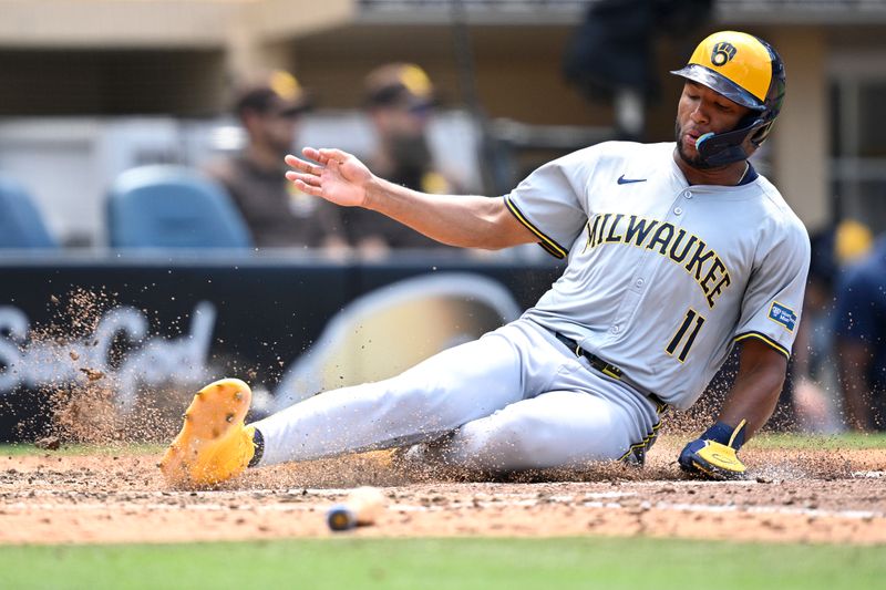 Jun 23, 2024; San Diego, California, USA; Milwaukee Brewers right fielder Jackson Chourio (11) slides home to score a run against the San Diego Padres during the seventh inning at Petco Park. Mandatory Credit: Orlando Ramirez-USA TODAY Sports