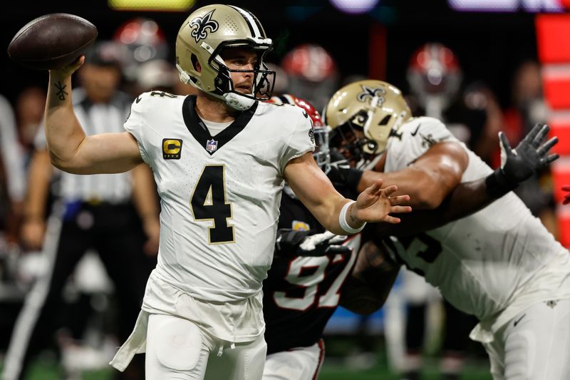 New Orleans Saints quarterback Derek Carr (4) works against the Atlanta Falcons during the second half of an NFL football game, Sunday, Sept. 29, 2024, in Atlanta. (AP Photo/Butch Dill)