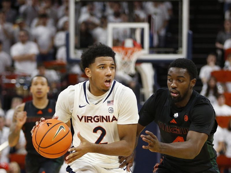 Feb 5, 2024; Charlottesville, Virginia, USA; Virginia Cavaliers guard Reece Beekman (2) controls the ball as from Miami (Fl) Hurricanes guard Bensley Joseph (4) defends during the second half at John Paul Jones Arena. Mandatory Credit: Amber Searls-USA TODAY Sports