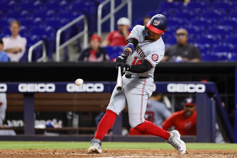 Apr 29, 2024; Miami, Florida, USA; Washington Nationals second baseman Ildemaro Vargas (14) hits a single against the Miami Marlins during the sixth inning at loanDepot Park. Mandatory Credit: Sam Navarro-USA TODAY Sports