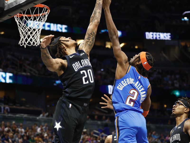 ORLANDO, FLORIDA - JANUARY 04: Shai Gilgeous-Alexander #2 of the Oklahoma City Thunder shoots the ball as Markelle Fultz #20 of the Orlando Magic defends during the first quarter at Amway Center on January 04, 2023 in Orlando, Florida. NOTE TO USER: User expressly acknowledges and agrees that, by downloading and or using this photograph, User is consenting to the terms and conditions of the Getty Images License Agreement. (Photo by Douglas P. DeFelice/Getty Images)