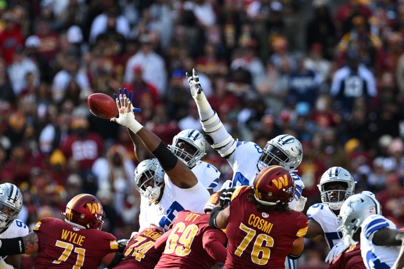 Dallas Cowboys special teams players defend a missed field goal attempt from Washington Commanders place kicker Austin Seibert during the first half of an NFL football game, Sunday, Nov. 24, 2024, in Landover, Md. (AP Photo/Terrance Williams)