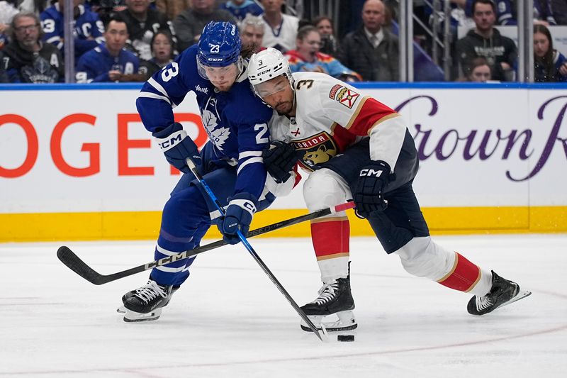May 5, 2025; Toronto, Ontario, CAN; Toronto Maple Leafs forward Matthew Knies (23) and Florida Panthers defenseman Seth Jones (3) battle for a puck during the third period of the second round of the 2025 Stanley Cup Playoffs at Scotiabank Arena. Mandatory Credit: John E. Sokolowski-Imagn Images