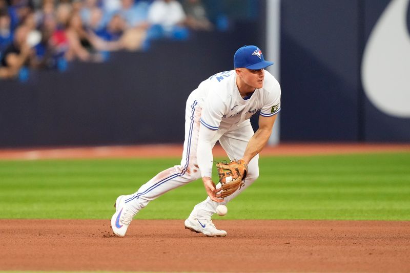 Jul 19, 2023; Toronto, Ontario, CAN; Toronto Blue Jays third baseman Matt Chapman (26) drops a ball hit by San Diego Padres shortstop Xander Bogaerts (not pictured) during the fourth inning at Rogers Centre. Mandatory Credit: John E. Sokolowski-USA TODAY Sports