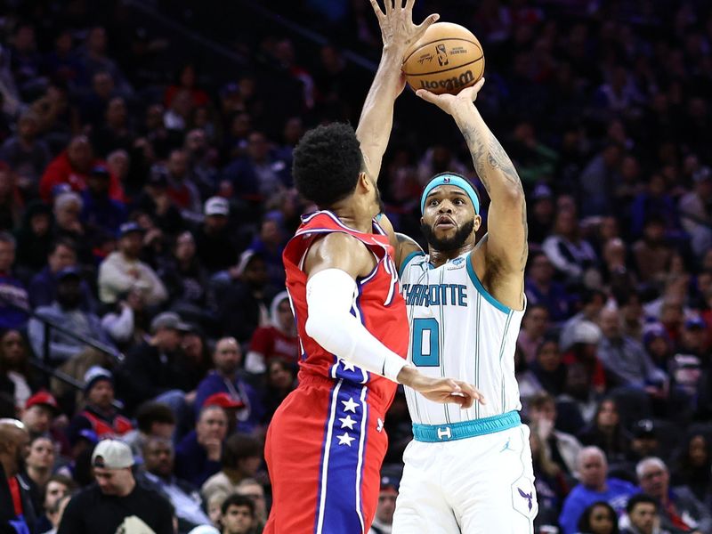 PHILADELPHIA, PENNSYLVANIA - MARCH 01: Miles Bridges #0 of the Charlotte Hornets shoots past Tobias Harris #12 of the Philadelphia 76ers during the second quarter at the Wells Fargo Center on March 01, 2024 in Philadelphia, Pennsylvania. NOTE TO USER: User expressly acknowledges and agrees that, by downloading and or using this photograph, User is consenting to the terms and conditions of the Getty Images License Agreement.  (Photo by Tim Nwachukwu/Getty Images)