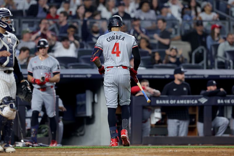 Jun 4, 2024; Bronx, New York, USA; Minnesota Twins shortstop Carlos Correa (4) walks back to the dugout after his fourth strikeout of the game during the ninth inning against the New York Yankees at Yankee Stadium. Mandatory Credit: Brad Penner-USA TODAY Sports