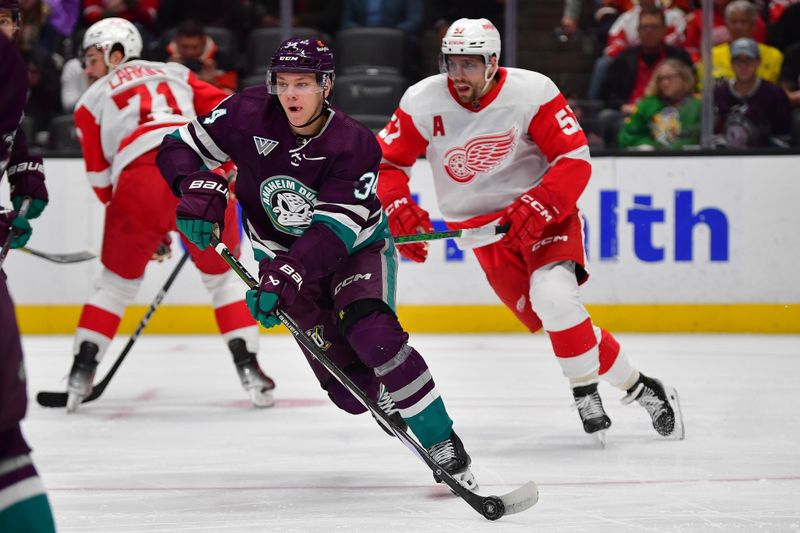 Jan 7, 2024; Anaheim, California, USA; Anaheim Ducks defenseman Pavel Mintyukov (34) moves the puck against the Detroit Red Wings during the first period at Honda Center. Mandatory Credit: Gary A. Vasquez-USA TODAY Sports