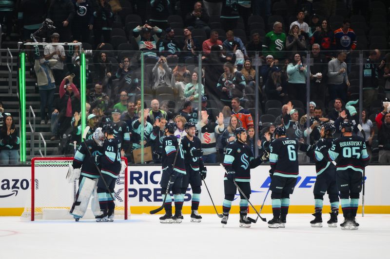 Oct 2, 2024; Seattle, Washington, USA; The Seattle Kraken celebrate defeating the Edmonton Oilers at Climate Pledge Arena. Mandatory Credit: Steven Bisig-Imagn Images